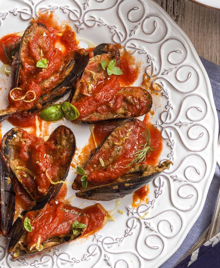 Stuffed mussels over a tomato reduction