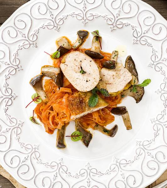 Guinea hen supreme with tomato-braised leeks and king oyster mushrooms sautéed in oil, garlic and parsley