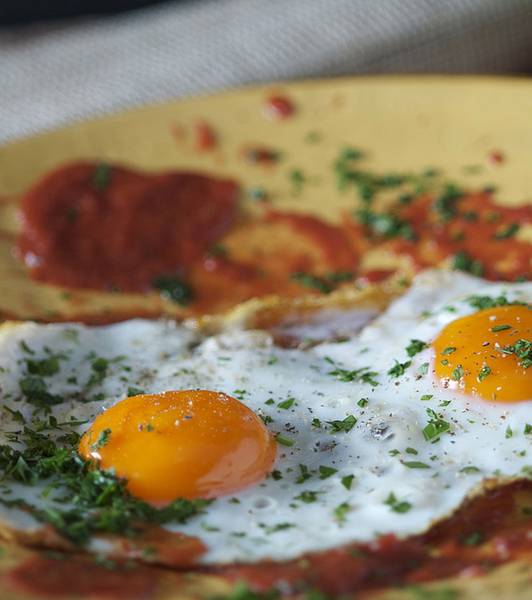 Fried egg sunny side up with tomato